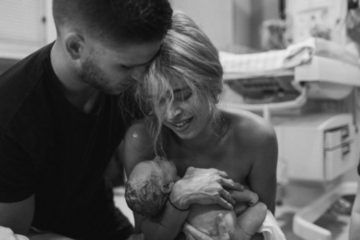 parents hold newborn baby First Hello Project