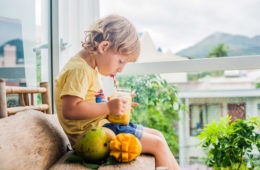 Boy drinking mango smoothie