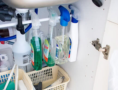 Clever idea: use a tension rod to hang spray bottles