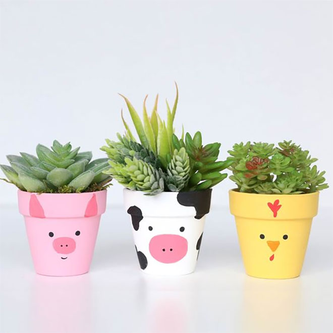 Three potted plants painted as farm animals