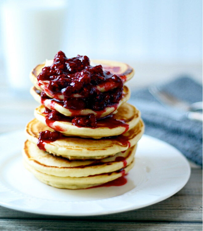 A yummy stack of scotch pancakes with berries and butter
