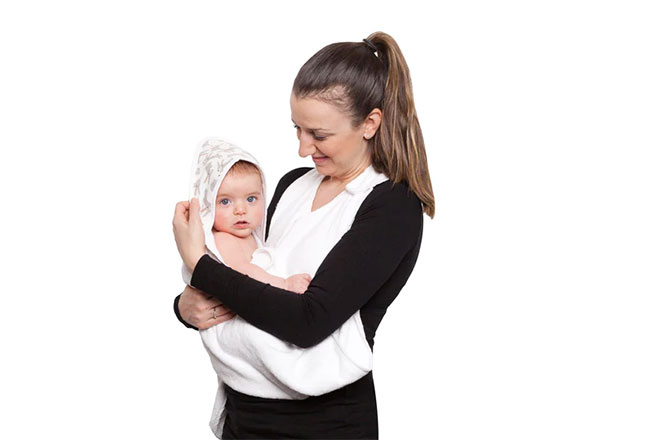 A mum holding her baby in a hooded apron towel from Towelling Stories
