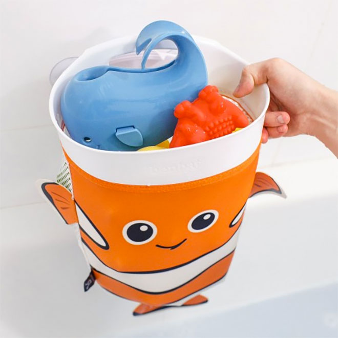 A hand holding the Benbat Scoop & Store Bath Toy Organiser filled with toys
