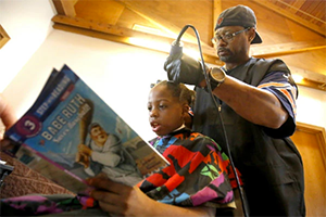 Iowa Barbar Courtney Holmes gives kids free haircuts if they read to him.