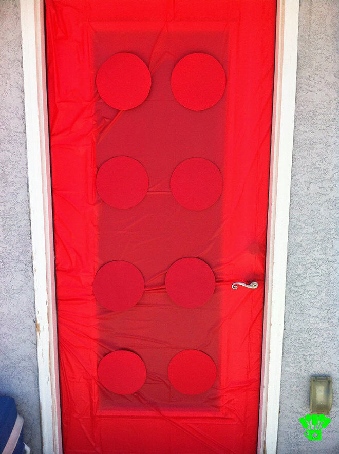 This cute LEGO door idea can be done using a plastic table cloth and cut out cardboard or coloured paper plates.