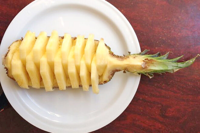 Cut a pineapple into quarters, cut out the flesh and slice into chunks. Perfect for a healthy party treat.