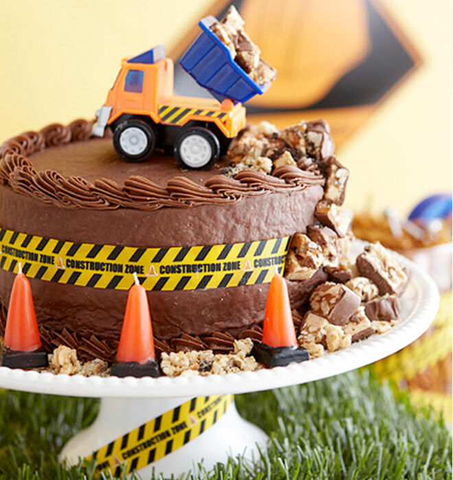 A construction cake dumping chocolate - we want one!