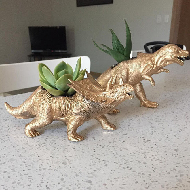 Simply pick up a plastic dinosaur or two from your local Kmart, cut out a hole in the top and spray paint that prehistoric baby gold. Voila! Instant cool dinosaur planter!