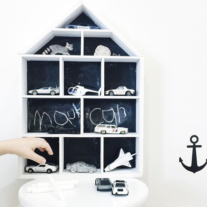 Remove the floral backing from the house-shaped shadow box, paint with chalkboard and use as a fun garage for the kids cars!