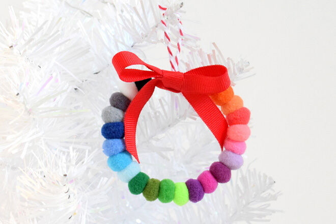 Grab your colourful pom poms and thread them onto some wire to make this colourful wreath ornament.