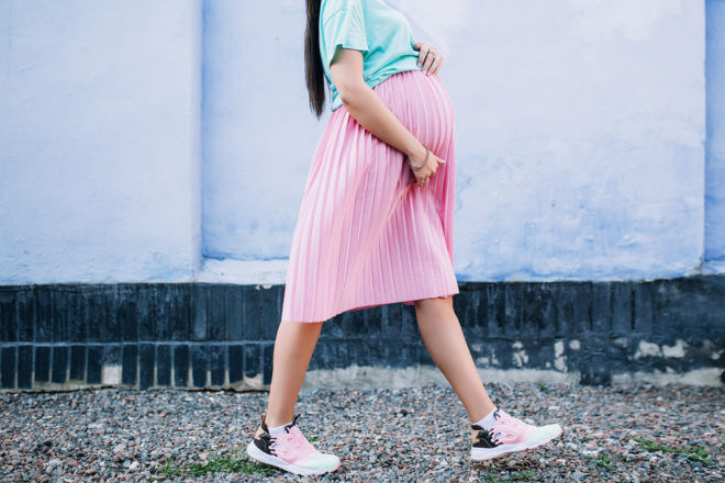 Pregnant walking pink skirt