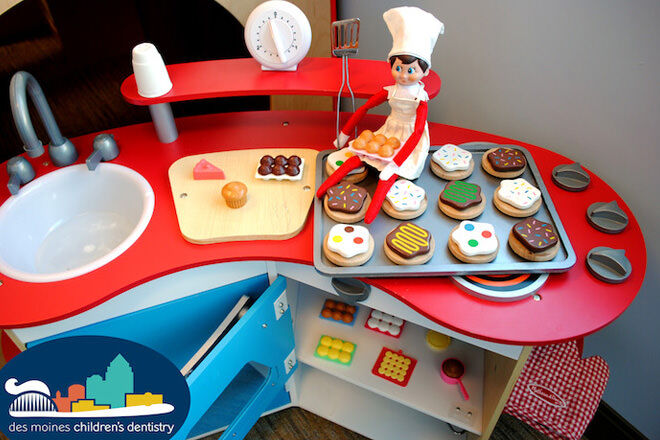 Elf on the Shelf cooking in a toy kitchen