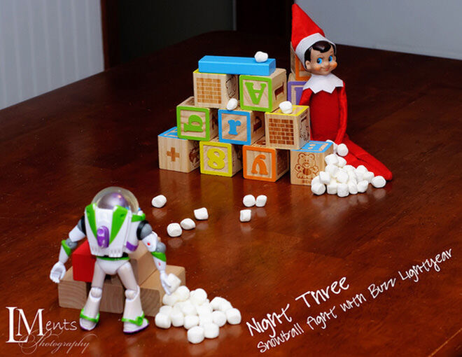 Elf on the Shelf and Buzz Lightyear have a snowball fight
