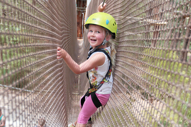 Girl on rope climb at Enchanted Adventure Garden