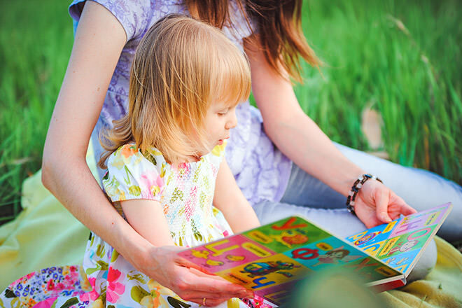 Mother and daughter reading a picture book