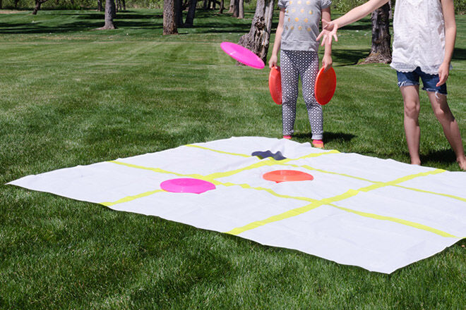Use a shower curtain and frisbees to play outdoor tic tac toe.