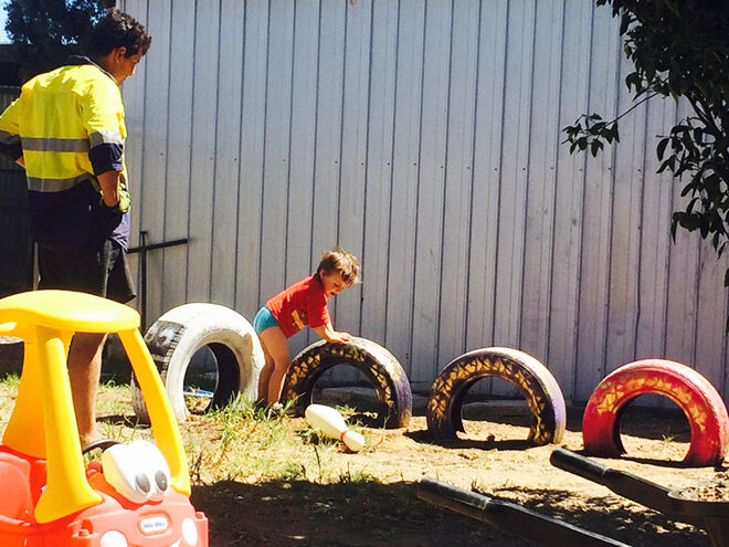 Using recycled old tyres as a climbing frame in the backyard.