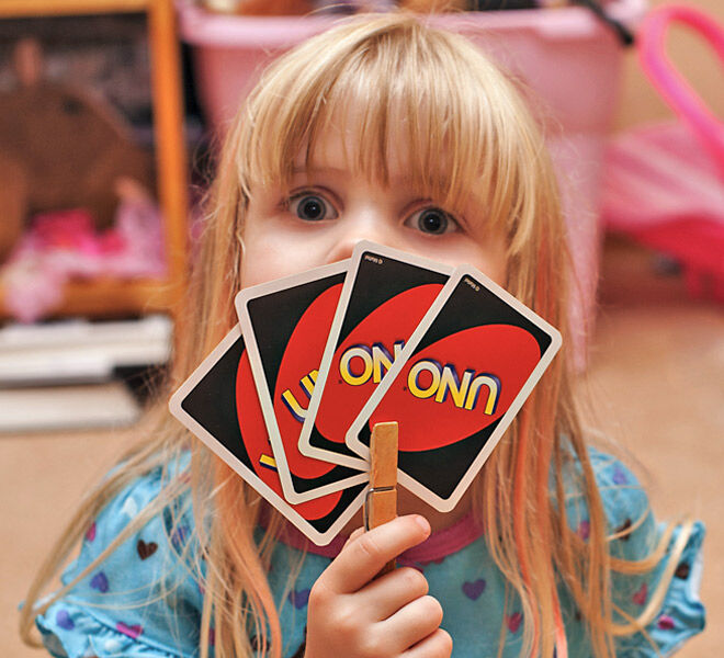 Parenting hack to help toddlers hold playing cards - use a clothes peg | Mum's Grapevine