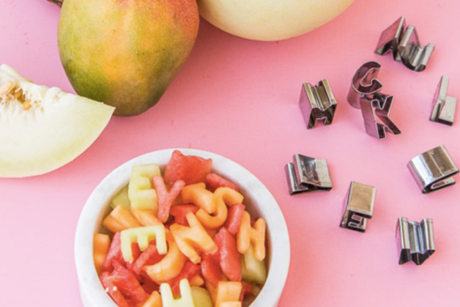 Cutting fruit in alphabet shapes with cookie cutters