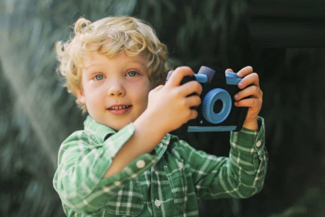 Young boy holding a camera