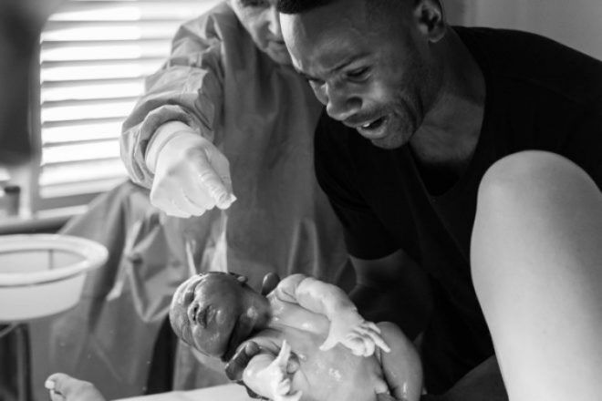father delivering baby First Hello Project