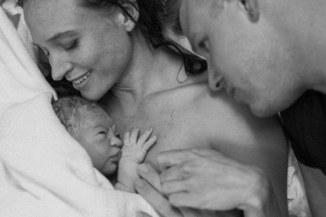 mother and father hold newborn baby First Hello Project
