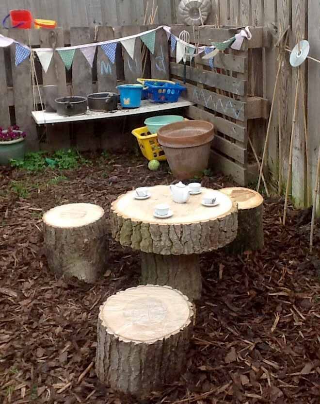 tree trunk table and chairs set in mud kitchen