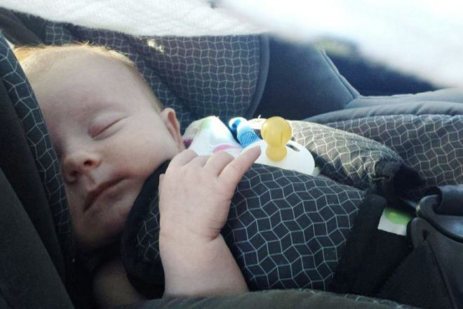 newborn asleep in car