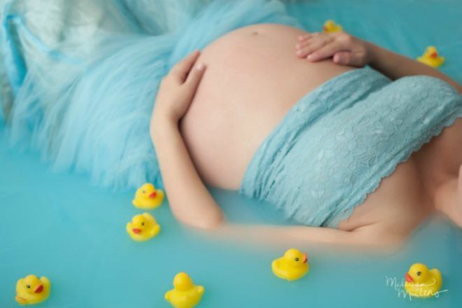 Pregnant woman bath with rubber ducks