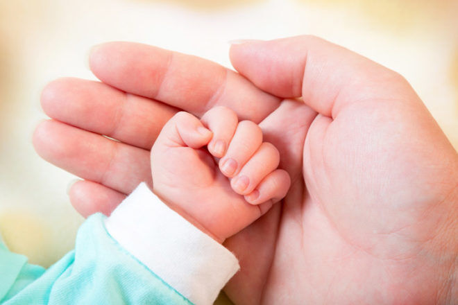 newborn fist in mother's hand