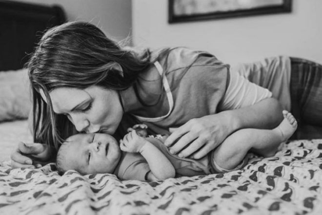 Mother and newborn on bed Alyssa Duncan Photography