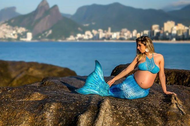 Pregnant mother as mermaid with city in background