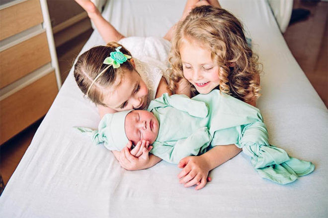 siblings meeting newborn baby