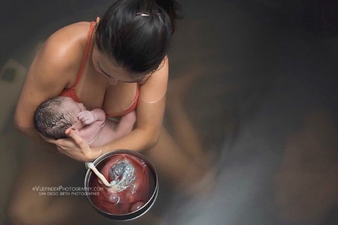 Mother with newborn and placenta water birth