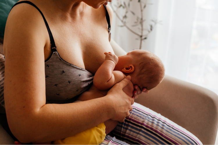 A mother and newborn breastfeeding in the crossover position