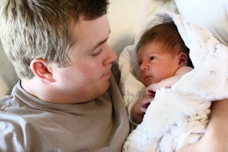 Dad holding a newborn baby