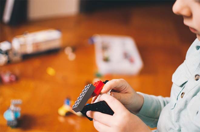 Child playing Lego to calm down