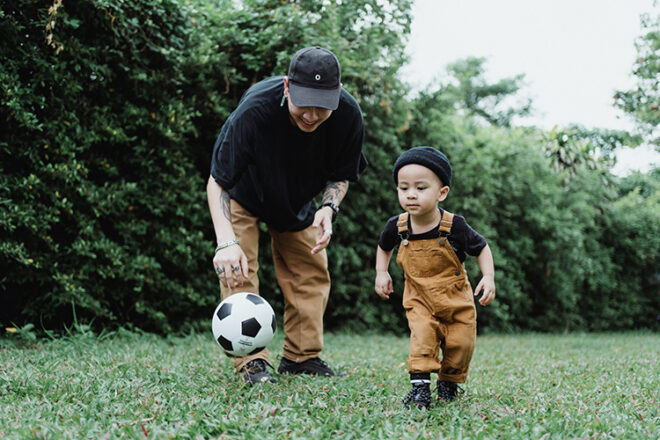 Boy playing ball with dad