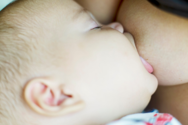 Breastfeeding newborn baby with a deep latch