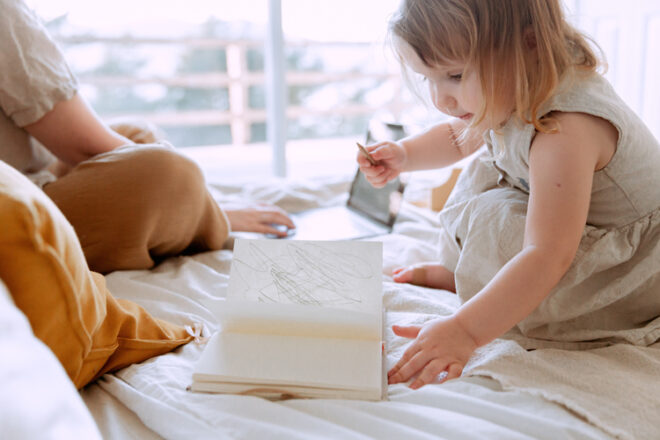 Child drawing in a book