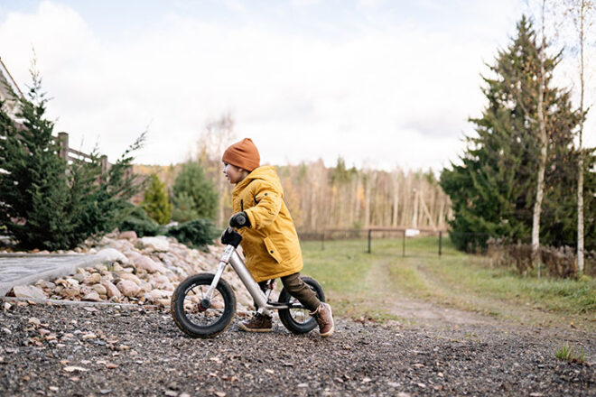 Toddler riding a balance bike