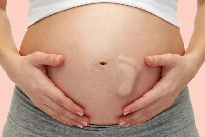 What to expect when baby starts to kick: baby foot pregnant belly