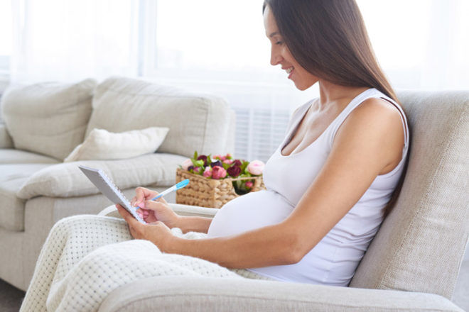 Pregnant mum writing a list birth plan