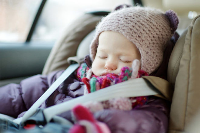 Baby asleep in car seat winter