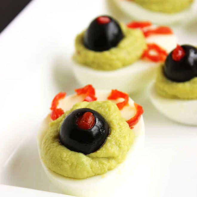 Scary devilled eggs with olives and avocado