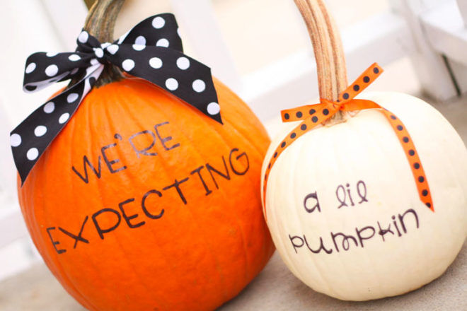 Halloween pregnancy announcement with pumpkins