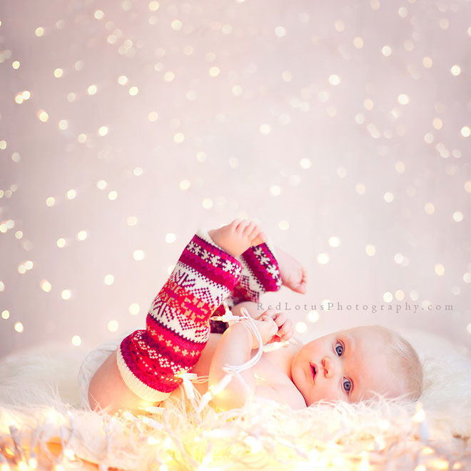 Baby's first Christmas photo, dressed in leg warmers with fairy lights