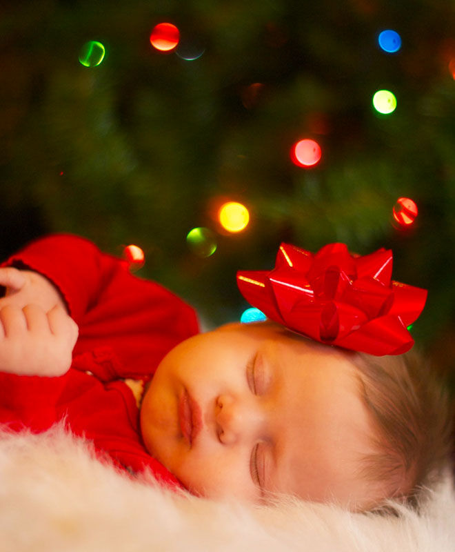 Baby's first Christmas photo with a bow in her hair