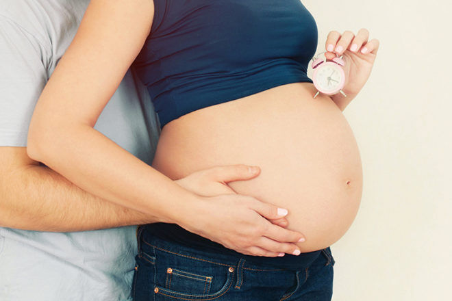 Pregnant belly with clock