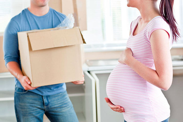 Helping pregnant woman lift boxes